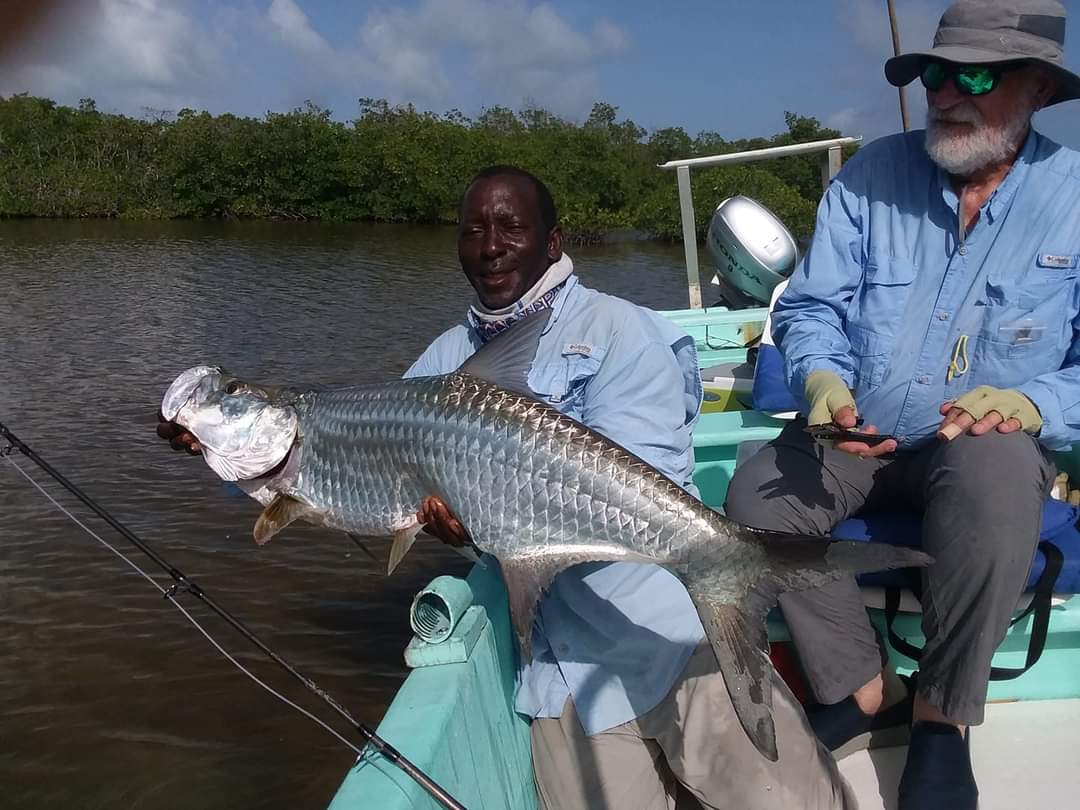 two men on a boat with large fish